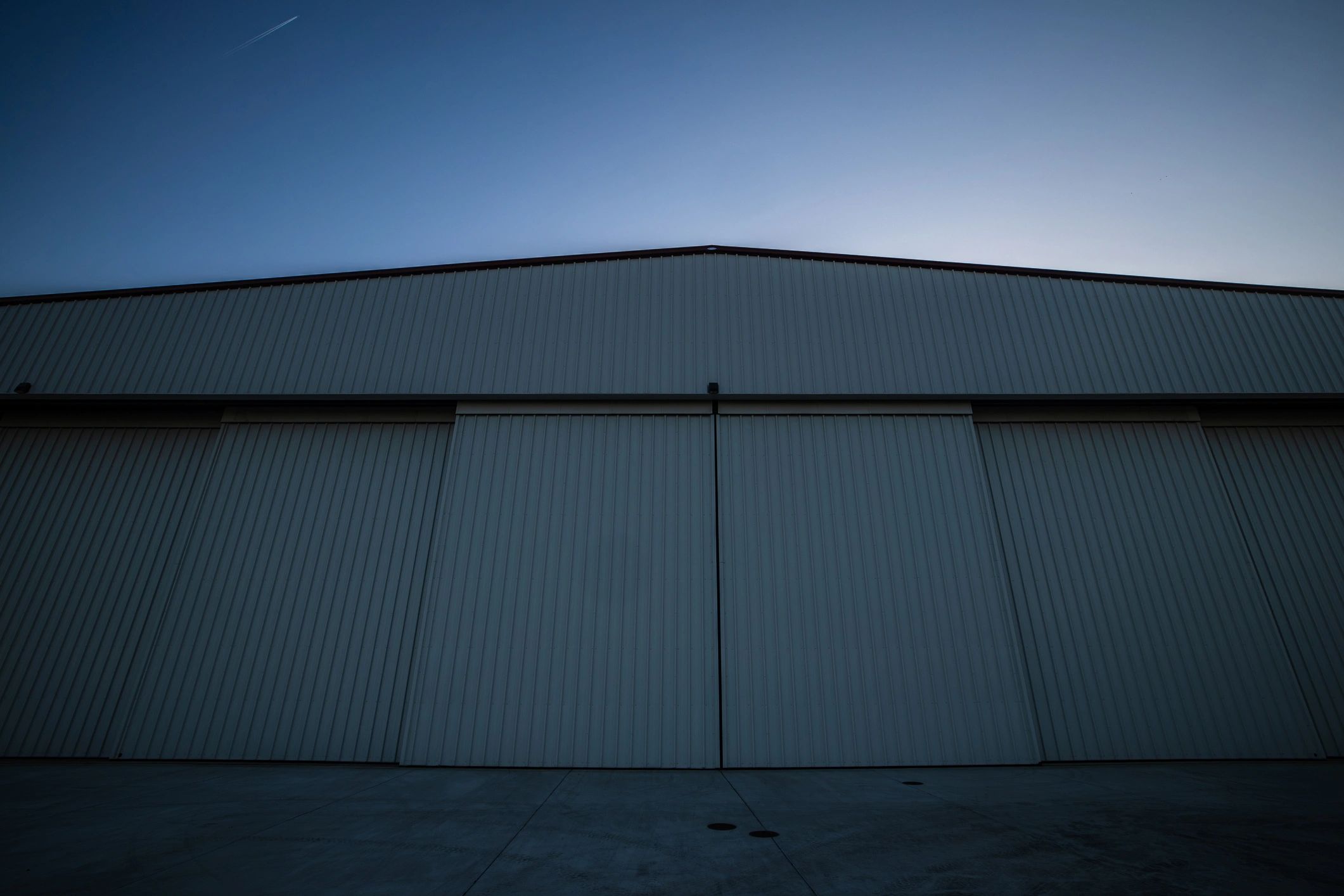 Minimal aircraft hangar with clean lines and a bright, neutral palette