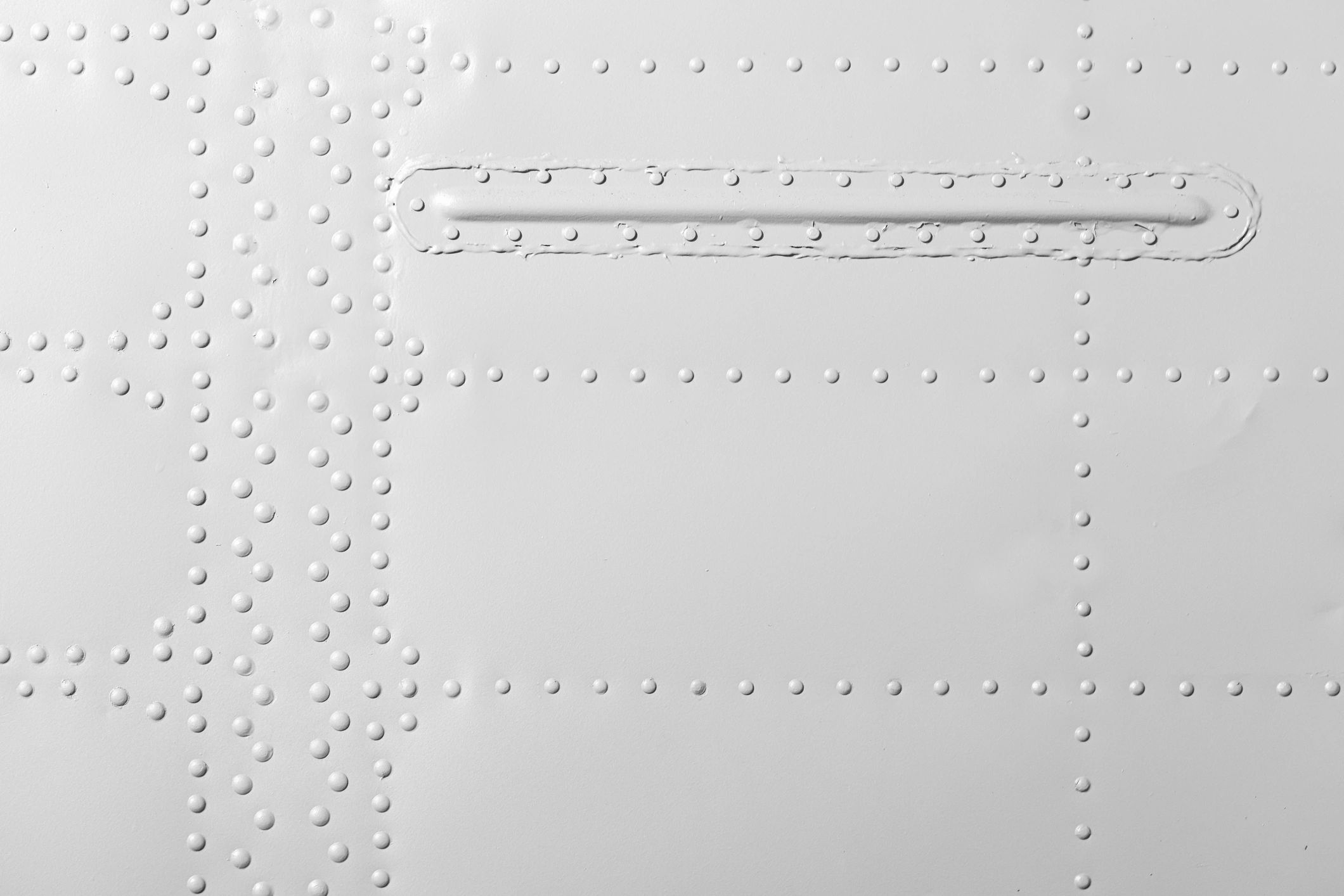 Sleek aerospace-inspired metal paneling with rivets and clean white finish